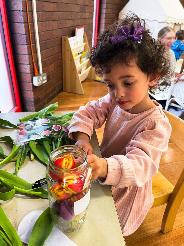 Child engaged in individual Montessori flower activity at ME Montessori