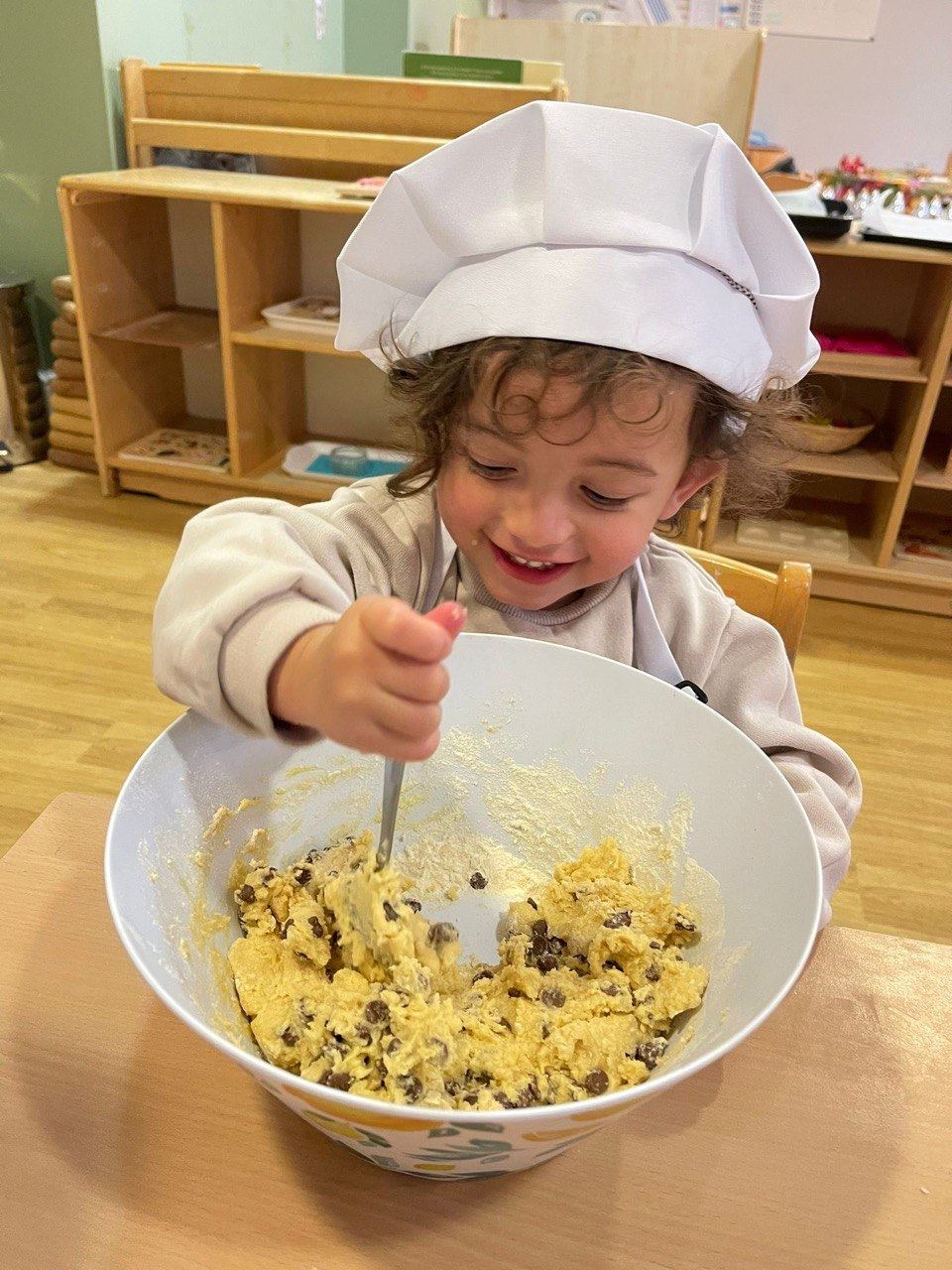 A child cooking at ME Montessori Nursery Aylesbury — practical life activities are central to the Montessori approach