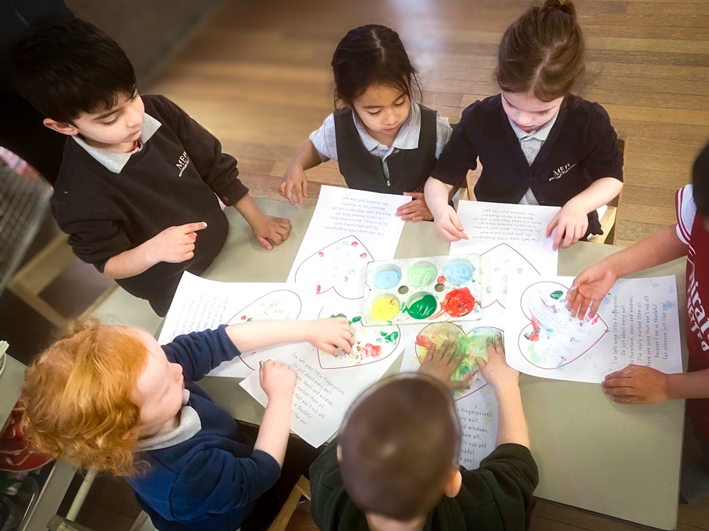 Children painting at ME Montessori Nursery Aylesbury — creative arts in the Montessori environment