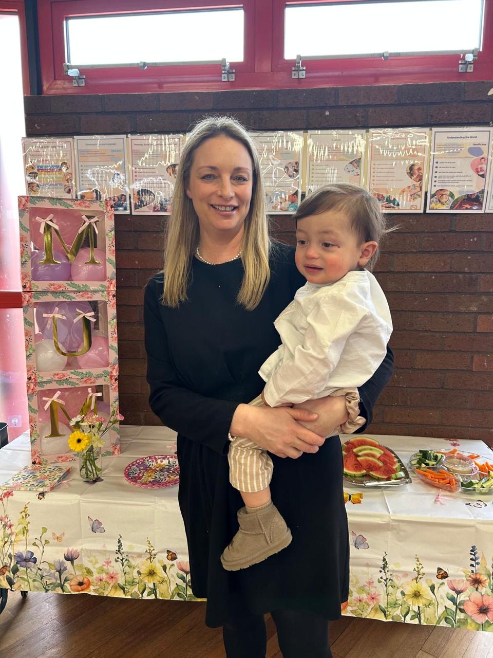 Key person holding a baby at ME Montessori Nursery Aylesbury — warm, consistent relationships