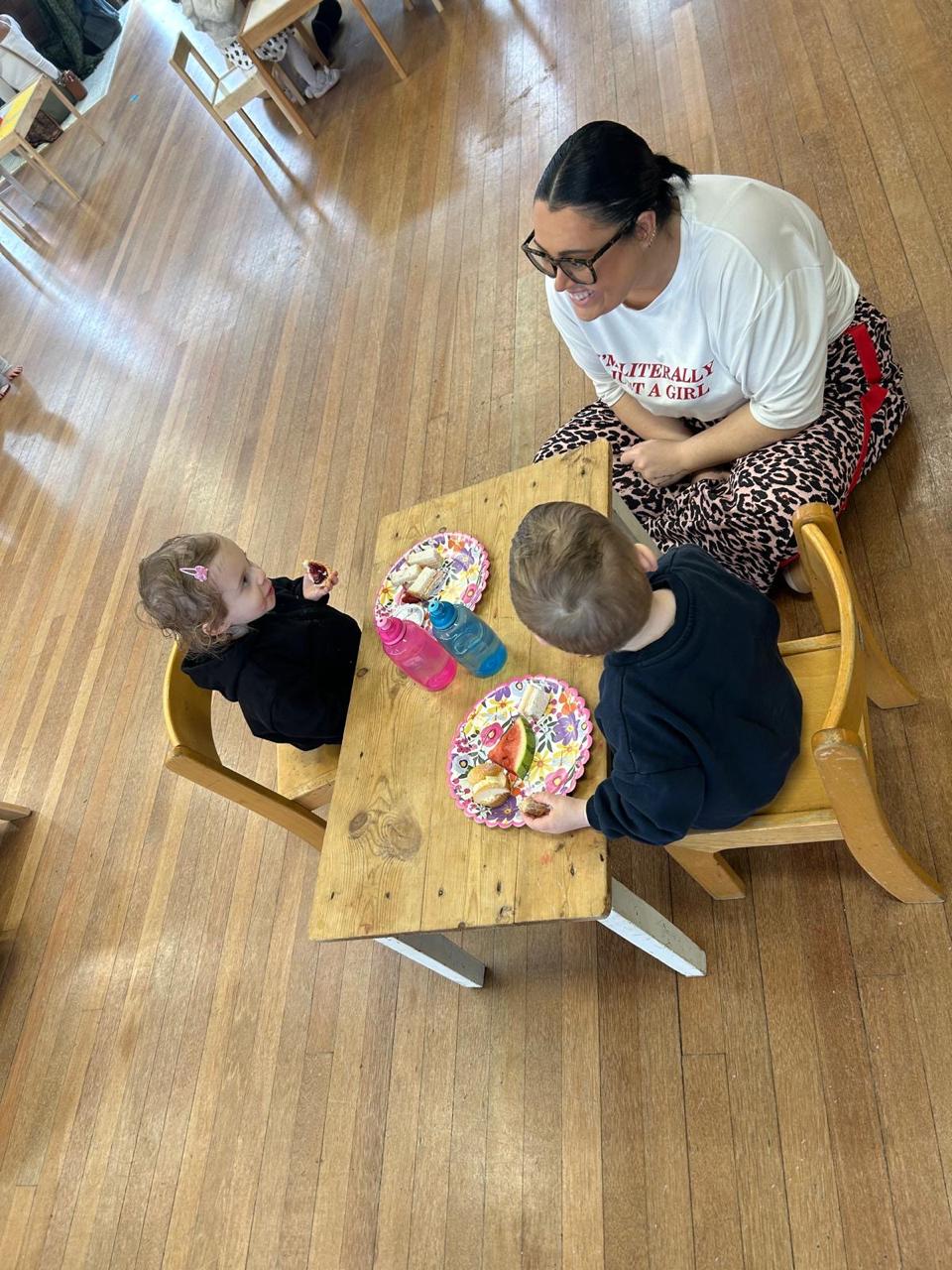 Key person at mealtime with an infant at ME Montessori Nursery — calm, connected mealtimes