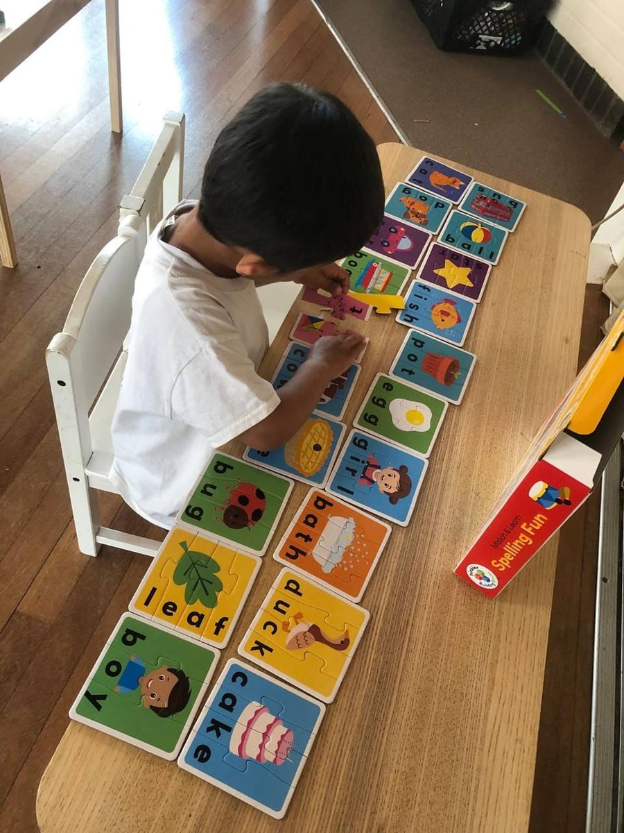 Child working on a spelling puzzle at ME Montessori Nursery Aylesbury — literacy through play
