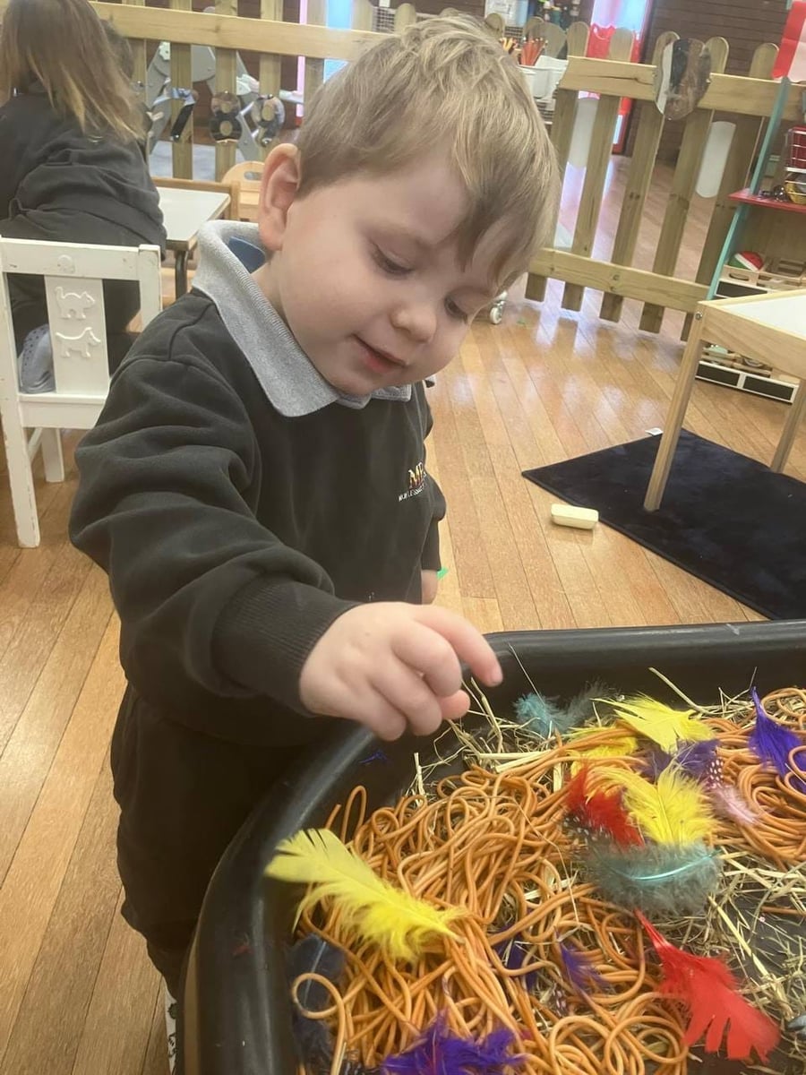 Toddlers in spaghetti sensory play at ME Montessori Nursery — messy play and exploration